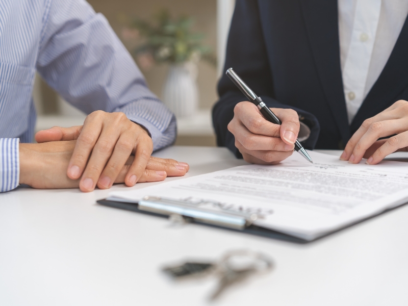 A landlord signing paperwork