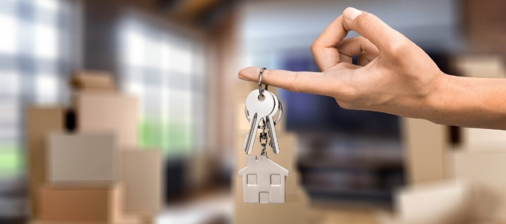 A hand holding some keys for moving house