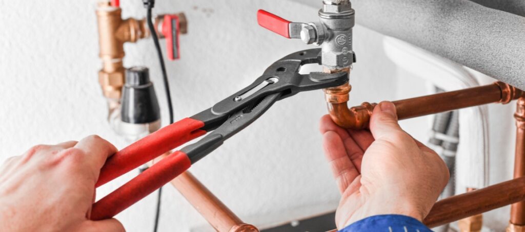 Plumbing maintenance conducted under a sink